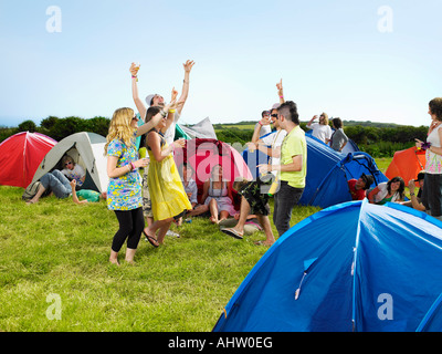Group partying outside tents Stock Photo