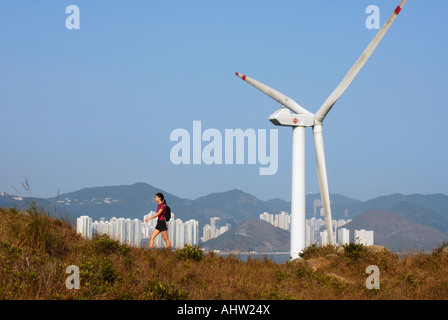 Hiker on Lamma Island with wind turbine in background, Hong Kong, China Stock Photo