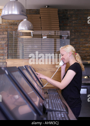 Woman on phone in a restaurant Stock Photo