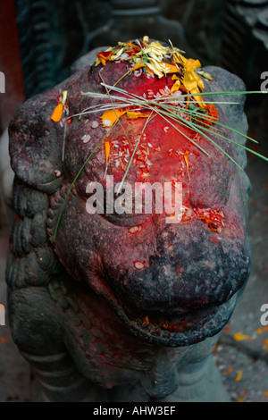 Stone lion with morning pooja in Patan Nepal Stock Photo