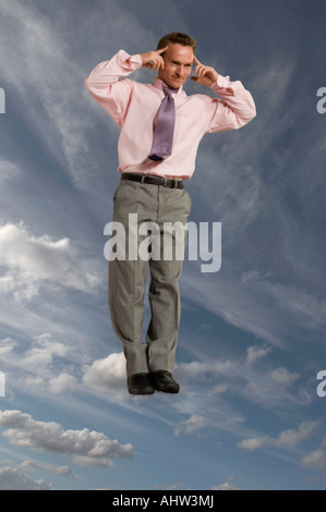 Businessman in the sky with hands to head Stock Photo