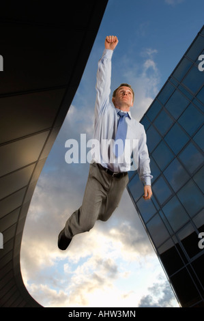 Businessman flying overtop of the city Stock Photo