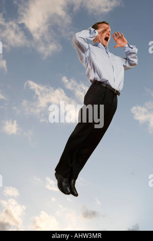 Businessman in the sky shouting Stock Photo