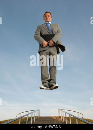 Businessman hovering above the ground Stock Photo