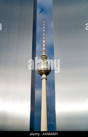 Vertical view of the TV tower 'Fernsehturm' taken through a modern metallic monument in Marx-Engels-Forum park. Stock Photo