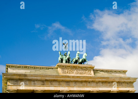 Horizontal view of the Goddess of victory statue adourning the top of the Brandenburg Gate on Pariser Platz on a sunny day Stock Photo