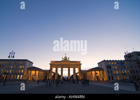 Horizontal wide angle of the Brandenburg Gate on Pariser Platz illuminated in the evening with lots of tourists. Stock Photo