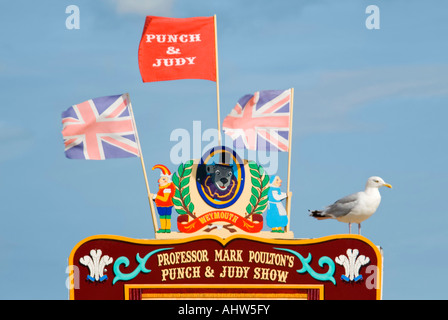 Horizontal close up of the top of a traditional Punch and Judy show on the beach at Weymouth. Stock Photo