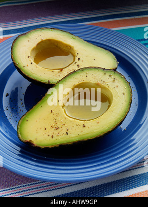 Two avocado halves with dressing editorial food Stock Photo