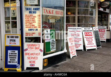 Notices outside a Fish and Chip shop on the seafront at Torquay Torbay in Devon England UK Stock Photo