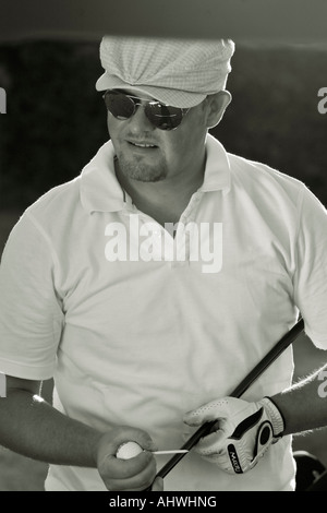 American golf courses golfer player caucasian man holding golfball golf ball and club in hand portrait image b&w Stock Photo