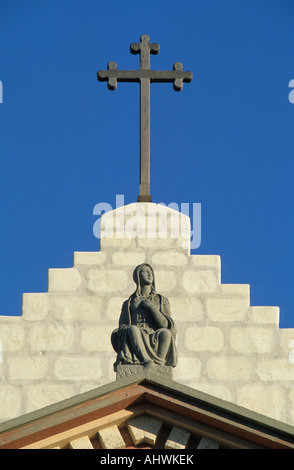 Religious Cross, Stone Facade and Statue atop Old Mission Santa Barbara in Santa Barbara, CA Stock Photo