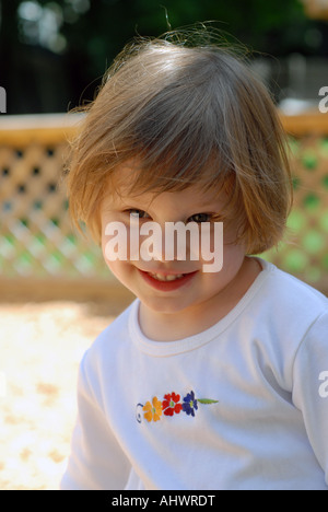 Four (4) year old girl plays in backyard playground Stock Photo
