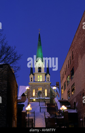 OUR LADY OF LOURDES CATHOLIC CHURCH FROM RIVERPLACE, ST. ANTHONY FALLS HISTORIC DISTRICT, MINNEAPOLIS, MINNESOTA.  WINTER; DUSK. Stock Photo