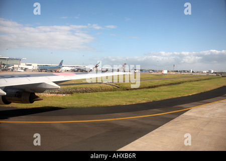 View from window of aircraft taxiing on runway at International Airport in Brisbane Queensland QLD Australia Stock Photo