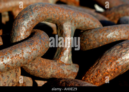 close up of the links in a length of large heavy duty industrial anchor chain rusty with corrosion and weathered Stock Photo