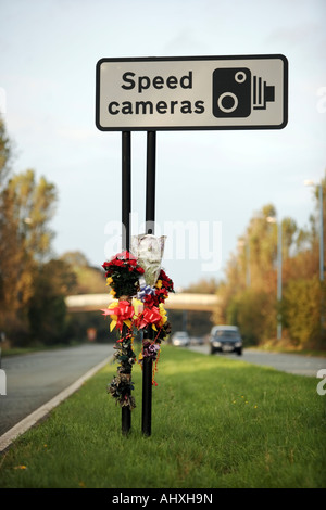 A floral tribute fastened to a speed camera sign at the scene of a road accident in Birmingham UK Stock Photo