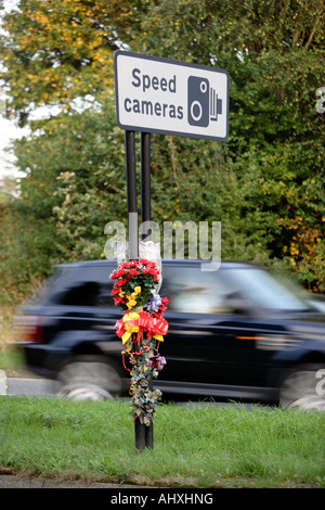A floral tribute fastened to a speed camera sign at the scene of a road accident in Birmingham UK Stock Photo