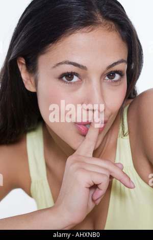 Portrait of woman with finger to lips Stock Photo