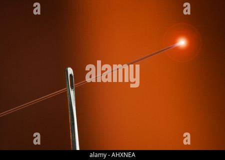 Glowing fiber optic thread with needle Stock Photo