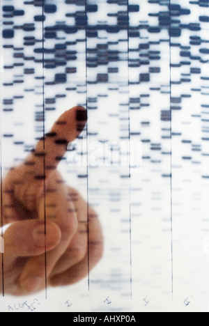 Hand pointing at DNA transparency Stock Photo