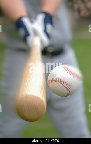 Closeup of baseball player hitting ball Stock Photo