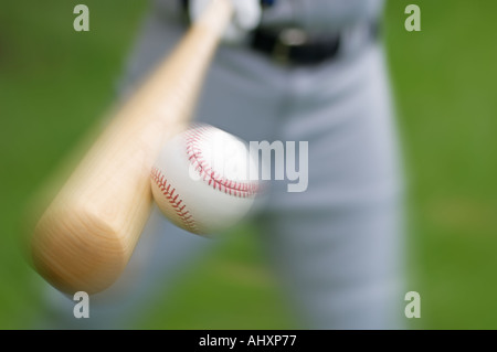 Closeup of baseball player hitting ball Stock Photo