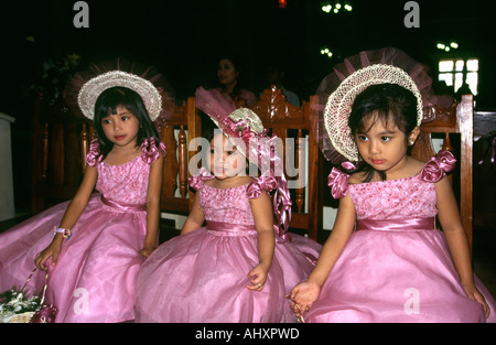 Philippines Manila Cathedral bridesmaids attending wedding Stock Photo