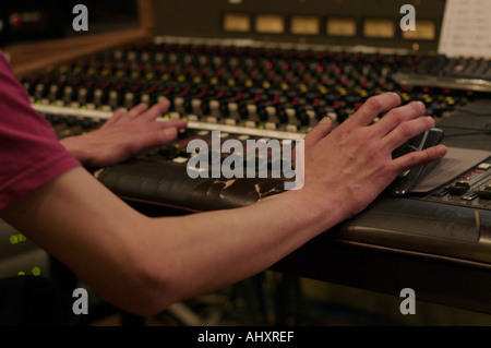 Sound editor adjusting dials in a recording studio Stock Photo