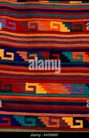 vendor seller selling textiles rug rugs carpet carpets at Saturday Market, Mercado Abastos, capital city of Oaxaca de Juarez in Oaxaca State in Mexico Stock Photo