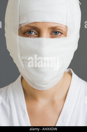 Woman’s face wrapped in bandages Stock Photo