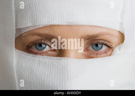 Woman’s face wrapped in bandages Stock Photo