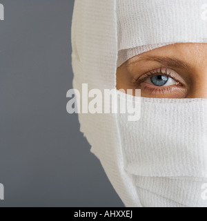 Woman’s face wrapped in bandages Stock Photo