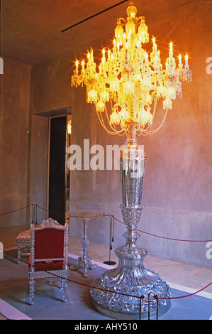 One of the museum piece giant candelabra and crystal chair and table, collector’s item made for maharajas and sheiks, in plush red velvet. At The Baccarat museum, shop, restaurant at the Hotel de Noailles in Paris. Designed by Philippe Starck. Stock Photo