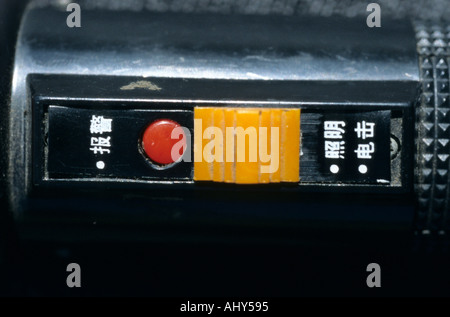 Close-up of a torch electric prod used in Tibetan prisons by Chinesee authority in tortures, featuring Chinese labels and a sliding switch. Stock Photo