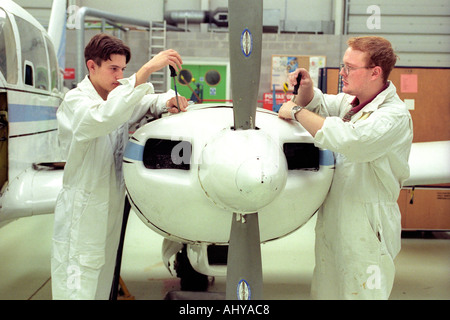 British Airways aircraft maintenance trainees working on a Piper Aztec Turbo Prop at training facility in Barry South Wales UK Stock Photo