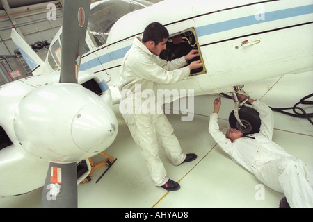 British Airways aircraft maintenance trainees working on a Piper Aztec Turbo Prop at training facility in Barry South Wales UK Stock Photo