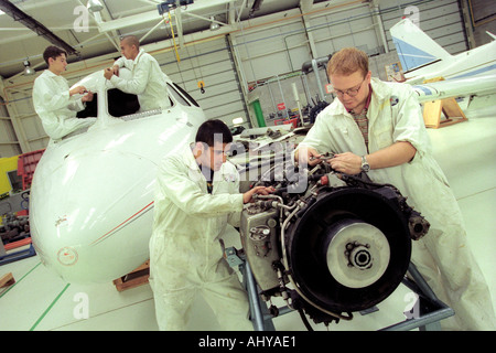 British Airways aircraft maintenance trainees working on a Hawker Siddley 125 jet at training facility in Barry South Wales UK Stock Photo