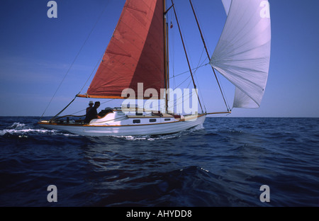 Small classic sailiing yacht running before the wind with a large MPS set Stock Photo