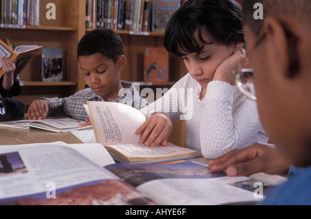 Latino African American Caucasian students studying in school library Stock Photo