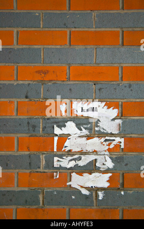 Partly removed post on two tone brick wall adjacent to the road running underneath the Eagle Centre car park in Derby, UK Stock Photo
