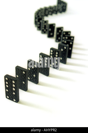 a Curving row of dominoes on a white background Stock Photo