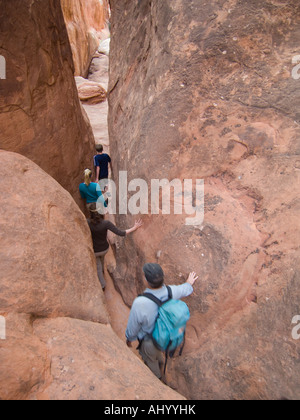 People walking through rock formations Stock Photo