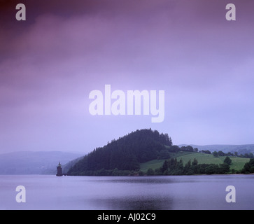 Dramatic view of the hills and straining tower under a storm laden sky across the reservoir Lake Vyrnwy Powys Wales Stock Photo