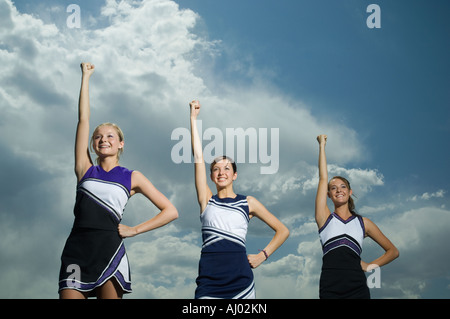 Cheerleaders with arms raised Stock Photo