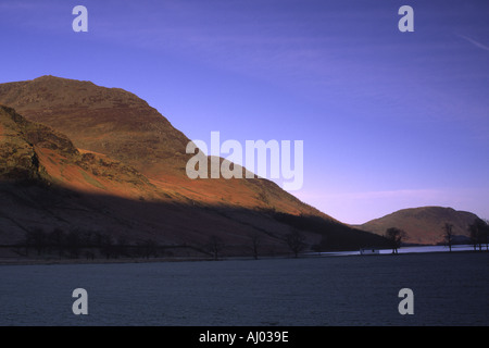 ENGLAND Cumbria Lake District National Park Early morning light illuminates the hills surrounding Lake Buttermere and Peggy  Stock Photo