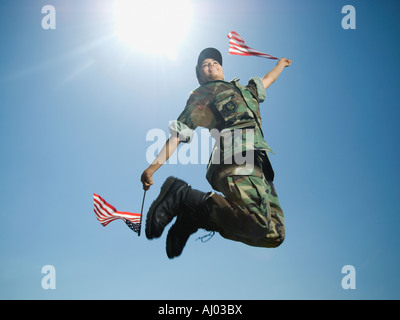 Female army soldier jumping Stock Photo