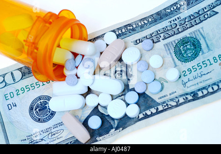 Pills spilled on 20 dollar bill Stock Photo