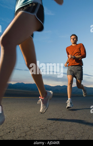 Couple in athletic gear running Stock Photo