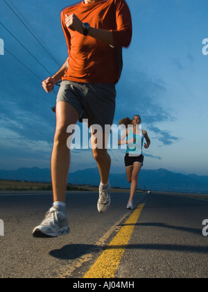 Couple in athletic gear running Stock Photo